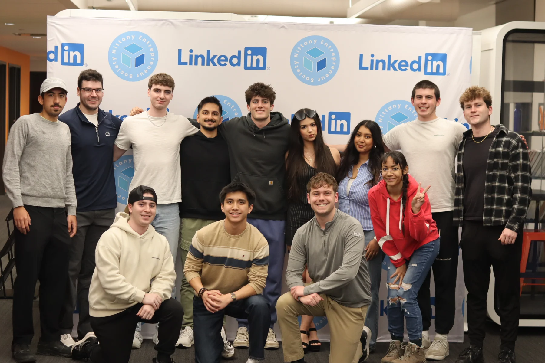 The NES executive team together in front of an NES and LinkedIn backdrop
