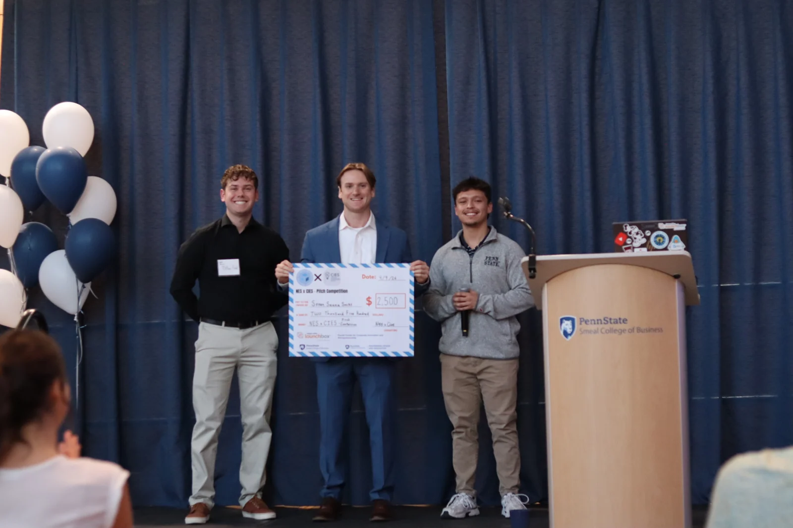 Soven receiving the $2,500 first-place check at the NES × CIES pitch competition